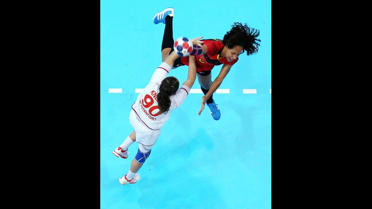 Carolina Morais of Angola throws over Milena Knezevic of Montenegro in a women's preliminary handball match Wednesday.