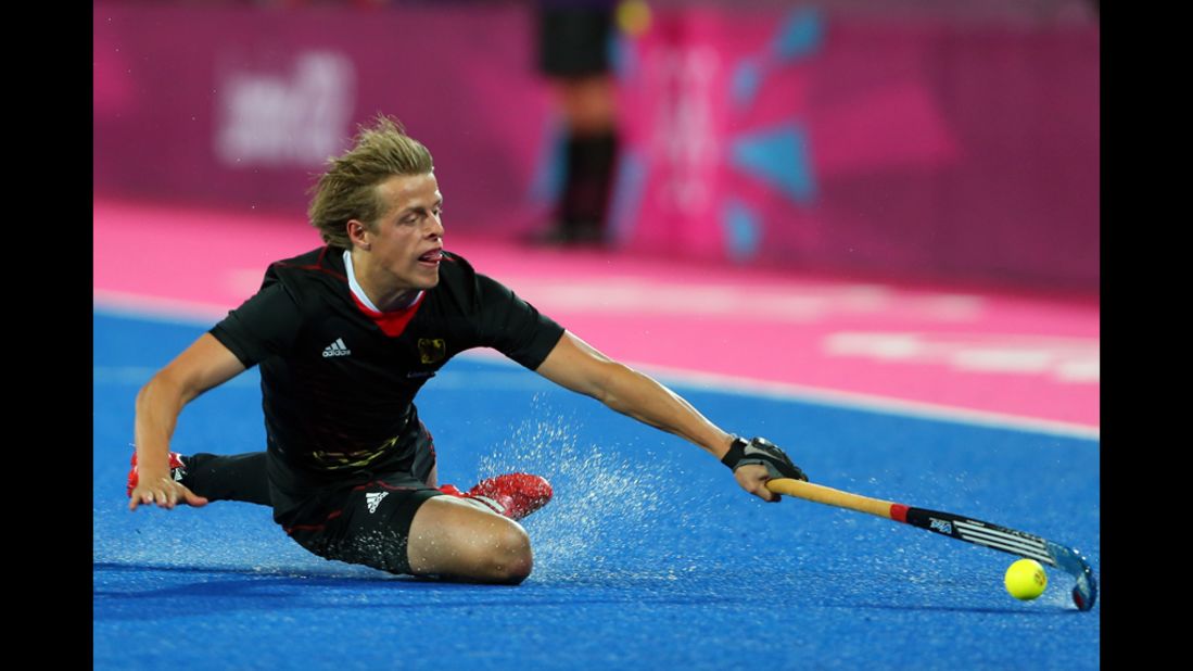 Germany's Benjamin Wess attempts to maintain control of the ball during the men's hockey match against South Korea.