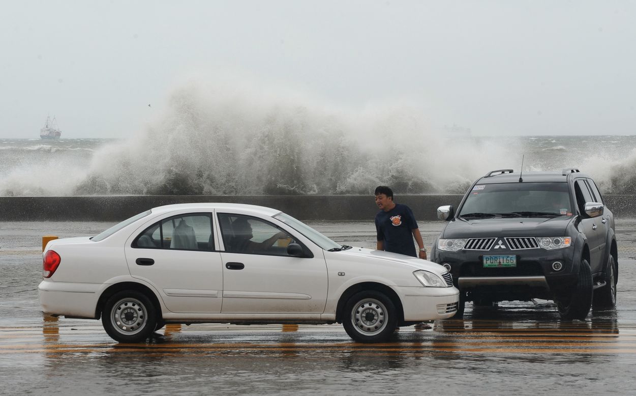 High waves splash up Wednesday along Toxas Boulevard, the famous roadway that runs along Manila Bay.