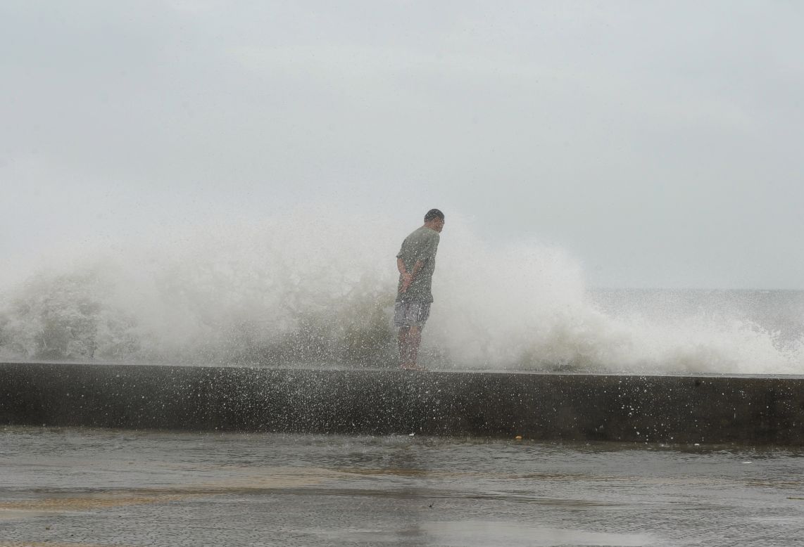 A man braves high waves along Manila's Roxas Boulevard on Wednesday.