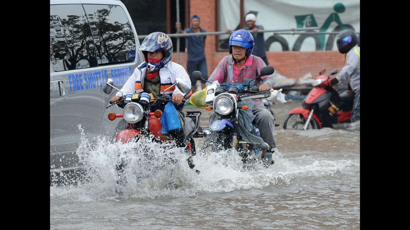 Motorists make their way through Manila's flooded streets Wednesday.