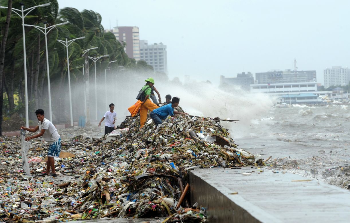 Locals pick through debris from the typhoon along Manila's Roxas Boulevard. 