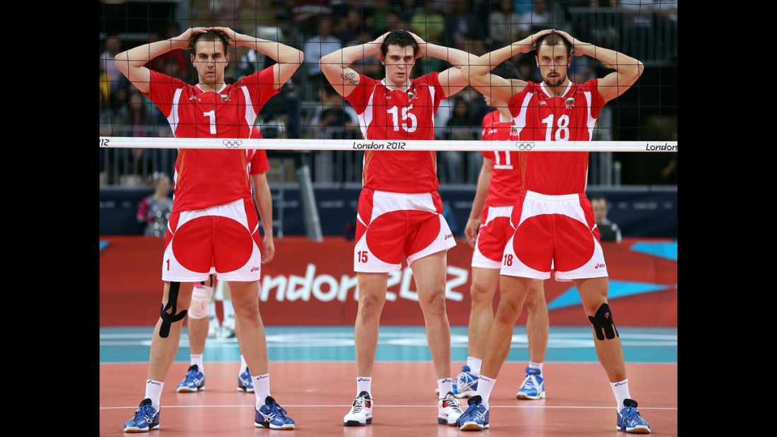 Bulgarian volleyball players, from left, Georgi Bratoev, Todor Aleksiev and Nikolay Nikolov wait for the serve in the second set against  Australia.