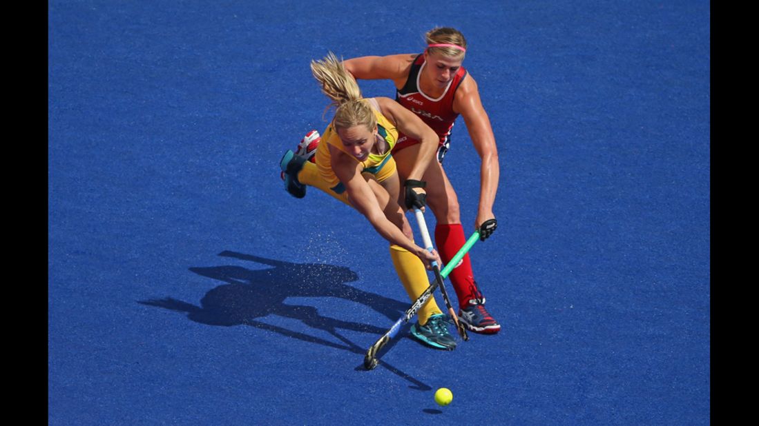 Katelyn Falgowski, right, of the United States goes after the ball with Fiona Boyce of Australia during a women's field hockey preliminary match.