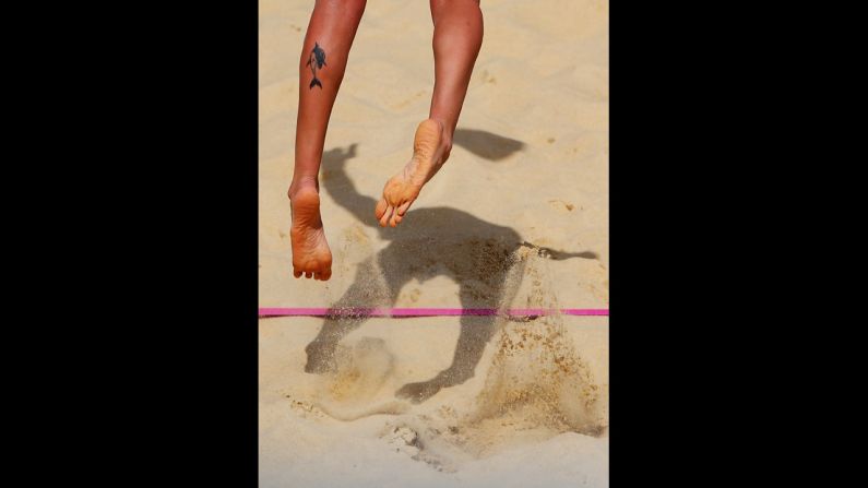 Italy's Greta Cicolari serves during a beach volleyball preliminary match against Canada.