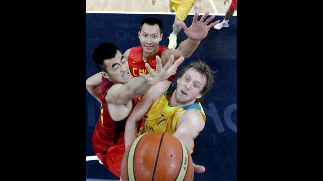 Australia's Joe Ingles tries to score against China's Wang Zhizhi, left, and Yi Jianlian during a men's basketball preliminary round.