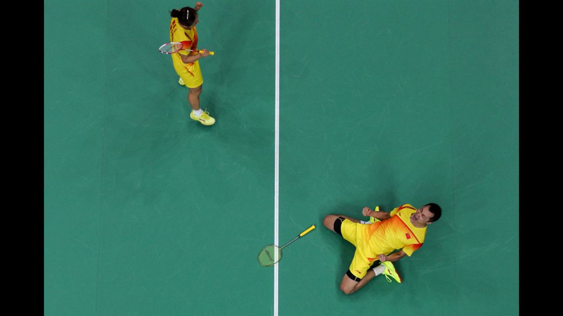 Jin Ma, left, and Chen Xu of China celebrate their victory over Indonesian foes in a mixed-doubles badminton semifinal.