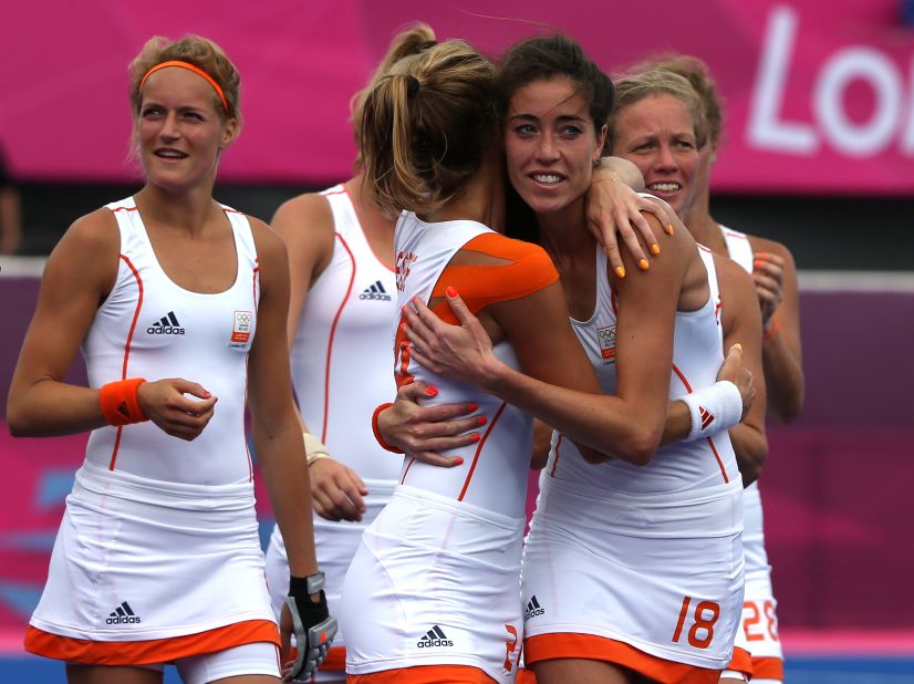 Naomi van As of the Netherlands hugs teammate Eva de Goede after their team defeated China in a women's field hockey preliminary match.