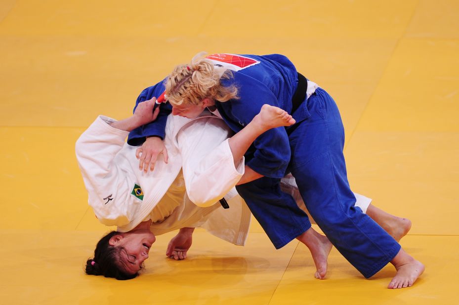 Mayra Aguiar of Brazil, in white, and Kayla Harrison of the United States compete in the women's under 78-kilogram judo event.