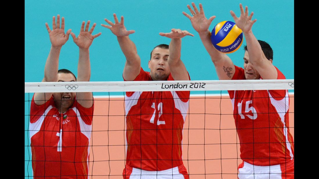 Bulgarian volleyball players, from left, Georgi Bratoev, Viktor Yosifov and Todor Aleksiev attempt to set during a preliminary match against Australia.
