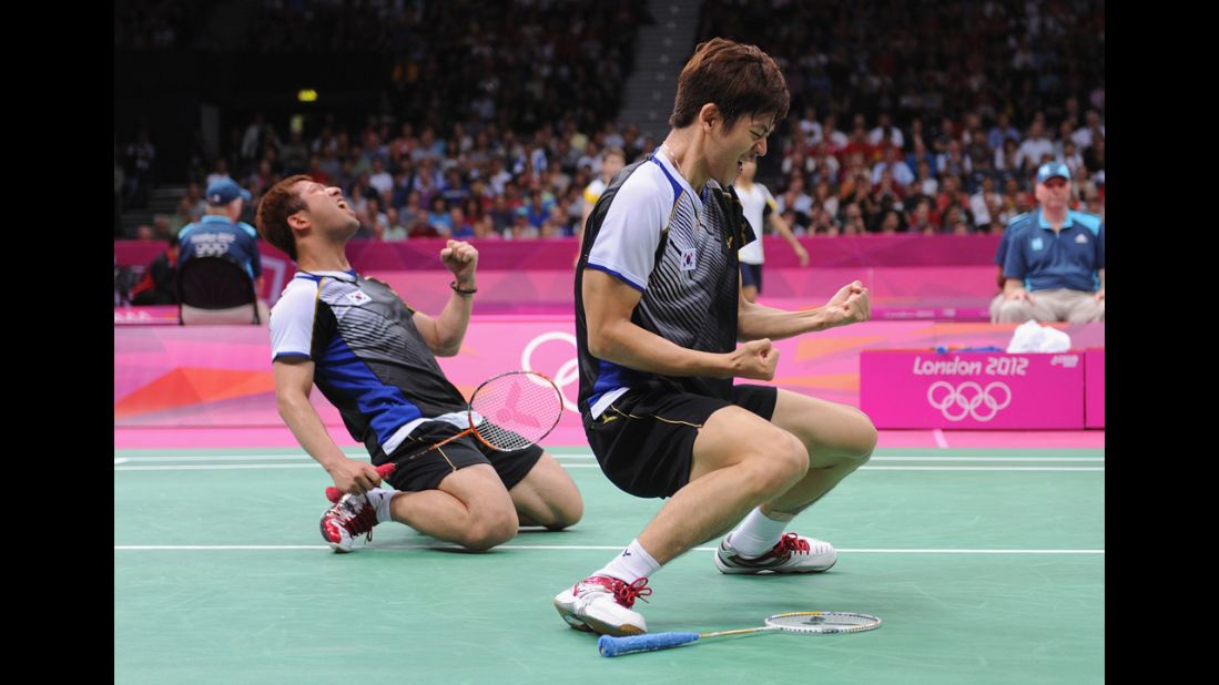 Yong Dae Lee, right, and Jae Sung Chung of South Korea celebrate their win over Indonesian opponents in the men's doubles badminton quarterfinal.