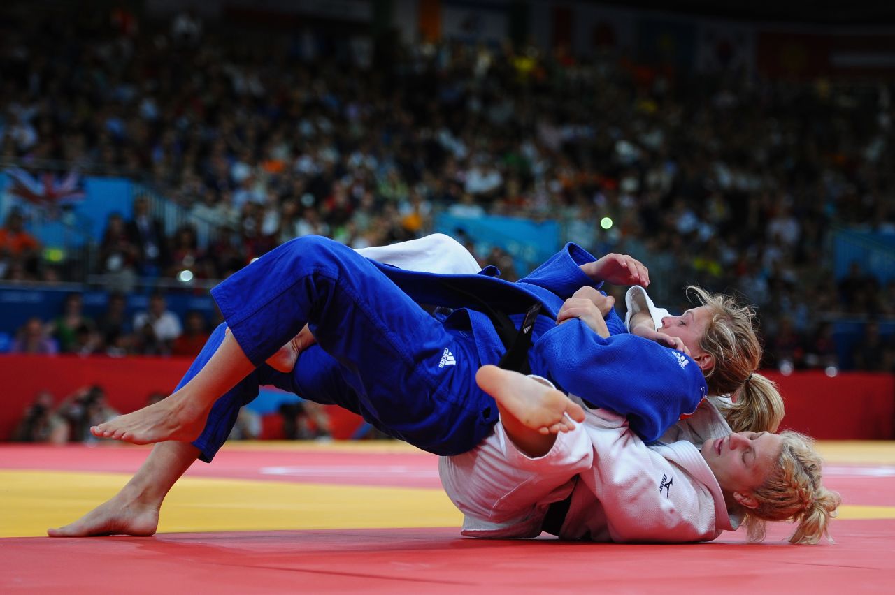 Kayla Harrison, in white, and Britain's Gemma Gibbons fight for first place.