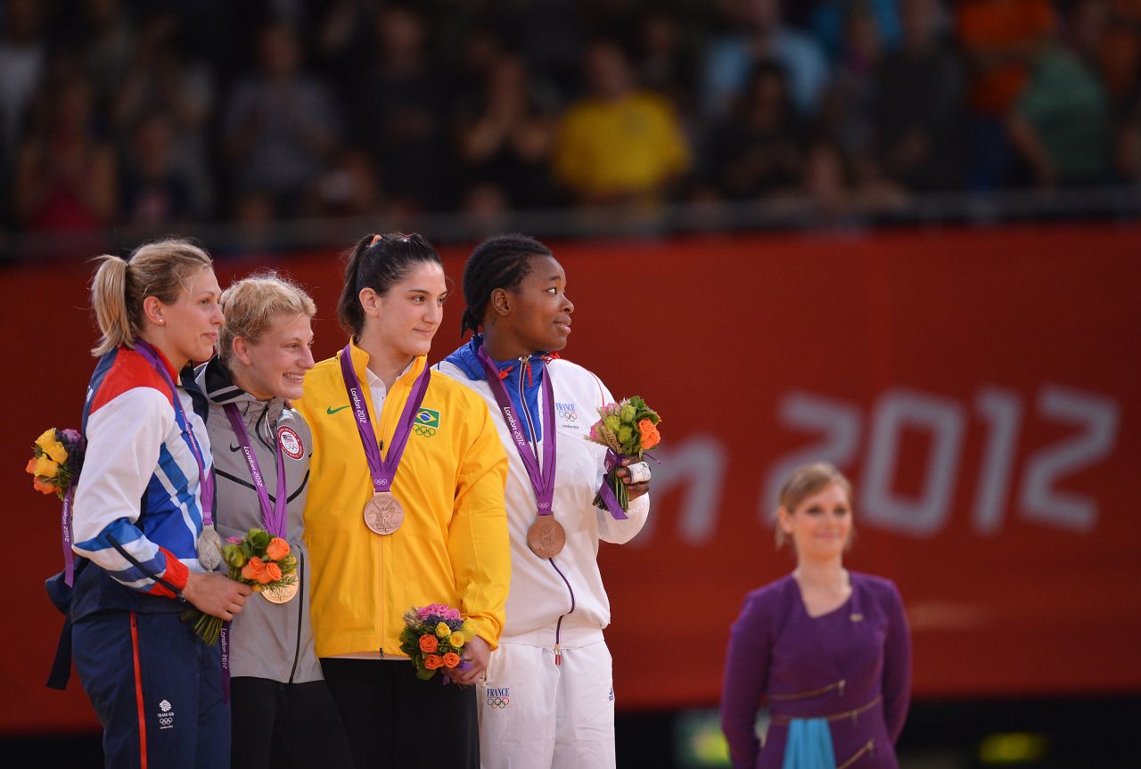 From left, Britain's silver medalist Gemma Gibbons, United States' gold medalist Kayla Harrison, Brazil's bronze medalist Mayra Aguiar, and France's bronze medalist Audrey Tcheumeo, pose on the podium after the women's judo competition.
