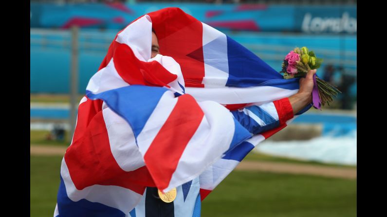 Gold medalist Etienne Stott of Great Britain celebrates after the medal ceremony for the men's canoe double slalom final.