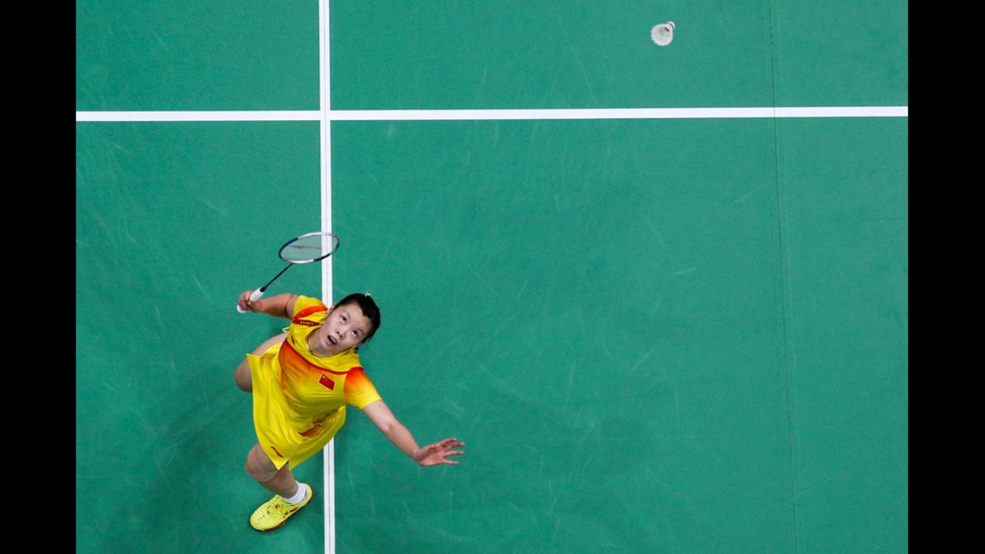 China's Xuerui Li returns a shot against Pui Yin Yip of Hong Kong in their women's singles badminton quarter final.