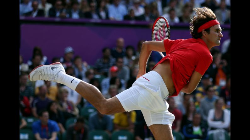 Roger Federer of Switzerland serves the ball to John Isner of the United States during the quarter-final of men's singles tennis.
