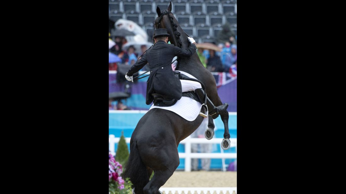 Canada's Marcus David loses control of his horse, Capital, in the dressage preliminaries.