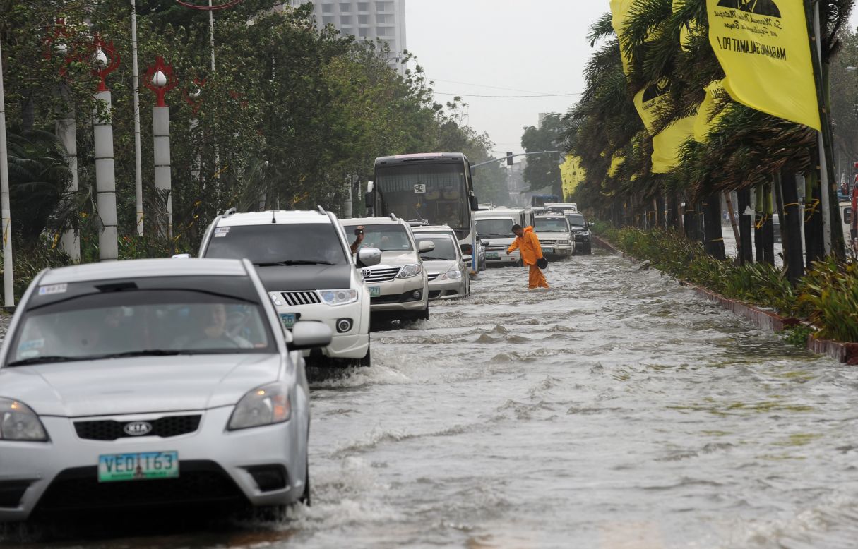 Motorists drive through floodwaters along Manila's Roxas Boulevard in Manila on Wednesday. 