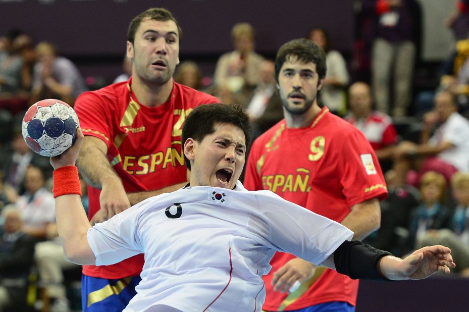 South Korea's Junggeu Park jumps to shoot during a men's preliminary handball match against Spain.