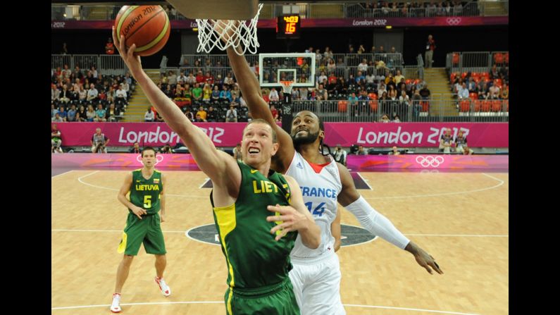 Lithuanian forward Darius Songaila, left, tries to score against French center Ronny Turiaf during a men's preliminary round basketball match.