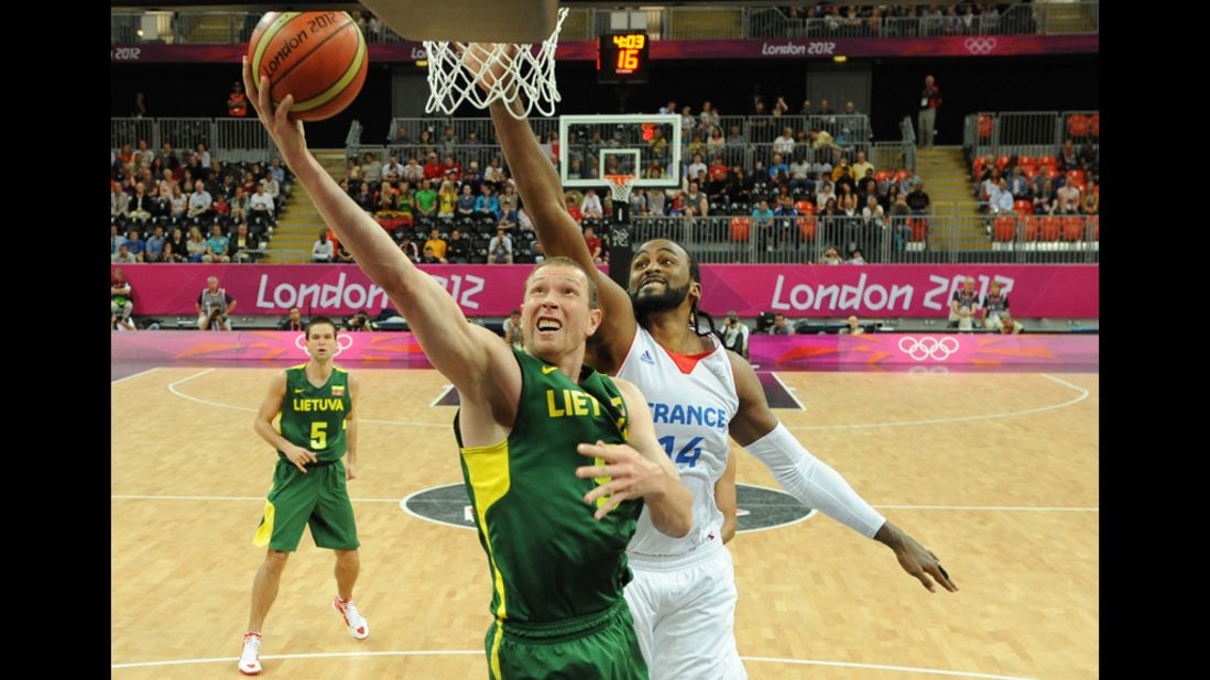 Lithuanian forward Darius Songaila, left, tries to score against French center Ronny Turiaf during a men's preliminary round basketball match.