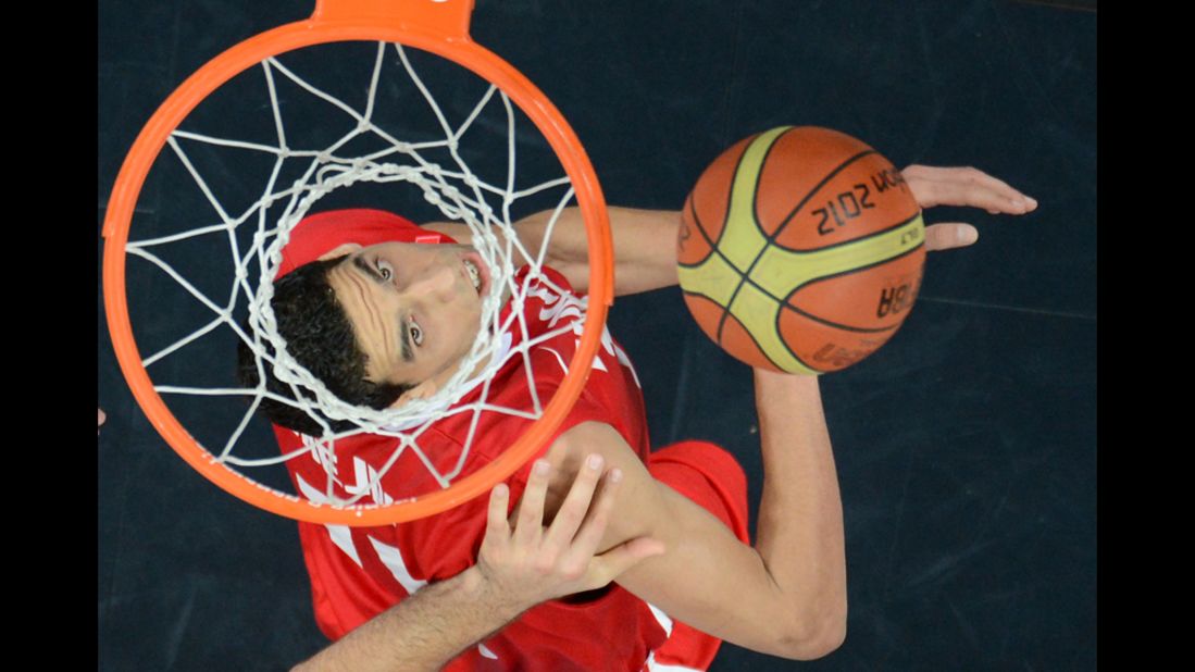 Tunisian center Salah Mejri scores during the men's preliminary round group A basketball match against Argentina.