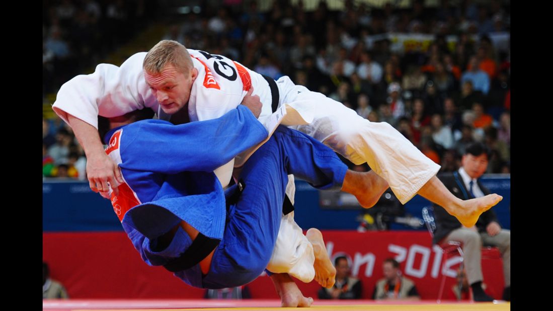 Dimitri Peters, in white, of Germany and Jevgenijs Borodavko of Latvia compete in the men's under 100-kilogram judo match.