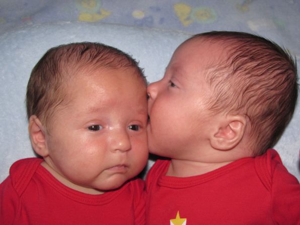 Andrew, right, gives his 3-month-old brother Patrick a kiss. 