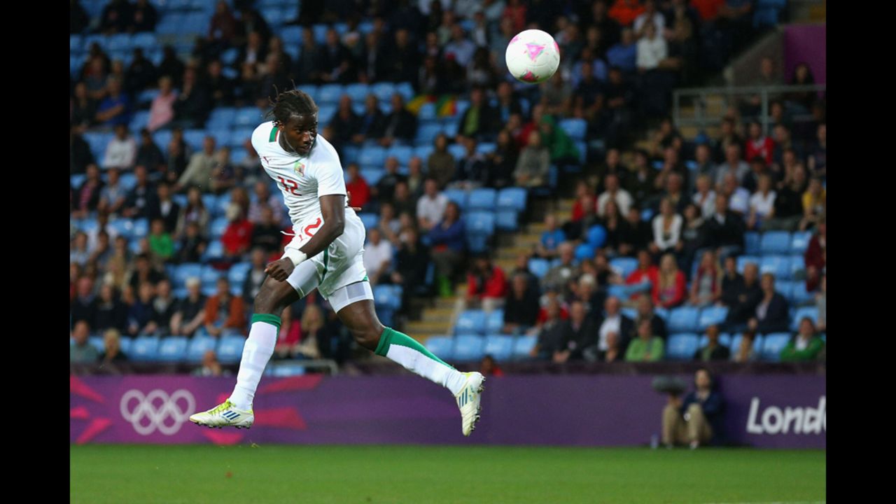 Ibrahima Balde of Senegal heads the ball during the men's football first round group D match against United Arab Emirates in Coventry, England.