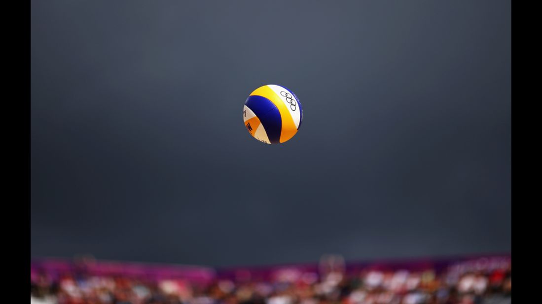The ball gets served during a men's beach volleyball match between Switzerland and Poland.