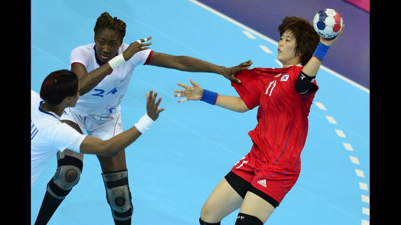 France's Mariama Signate, left, vies with South Korea's Ryu Eun Hee during a women's preliminary handball match.