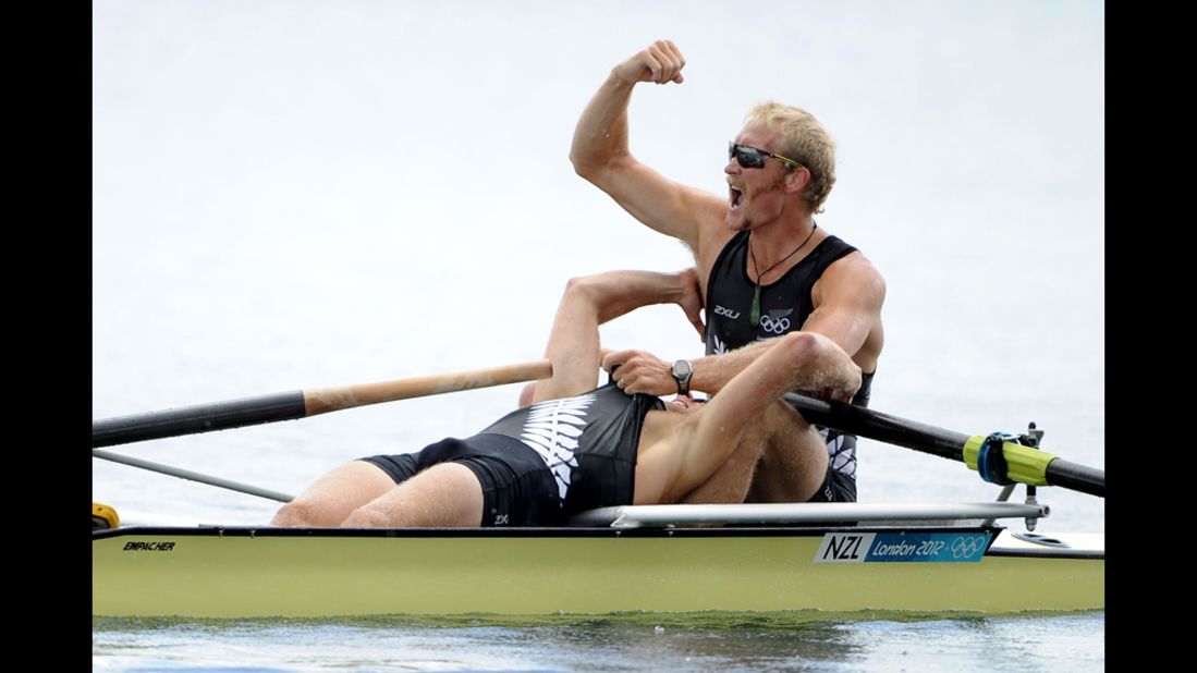 Hamish Bond and Eric Murray of New Zealand celebrate after winning gold in the men's pair at the Olympic rowing regatta.