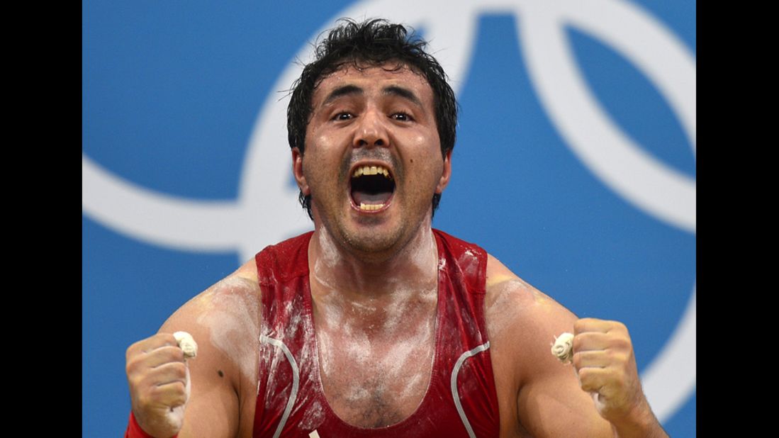 Uzbekistan's Sherzodjon Yusupov celebrates during the men's 85-kilogram weightlifting event.