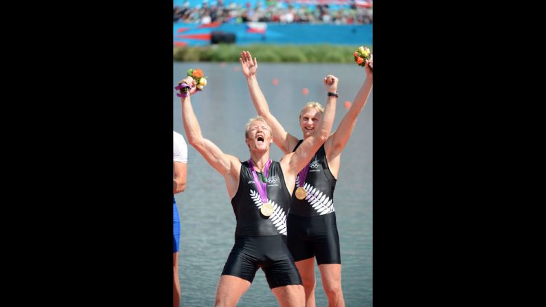 New Zealand's Eric Murray, left, and Hamish Bond celebrate with their gold medals during the ceremony for the men's pair at the Olympic rowing regatta.