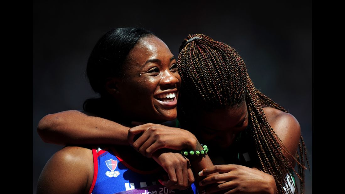 Marlena Wesh of Haiti rejoices after competing in the women's 400-meter heats.