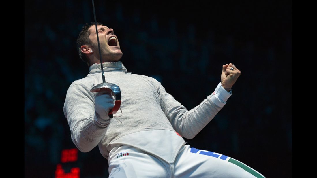 Italy's Aldo Montano celebrates gaining the qualifying point against Aliaksandr Buikevich of Belarus during the men's saber team quarterfinals.