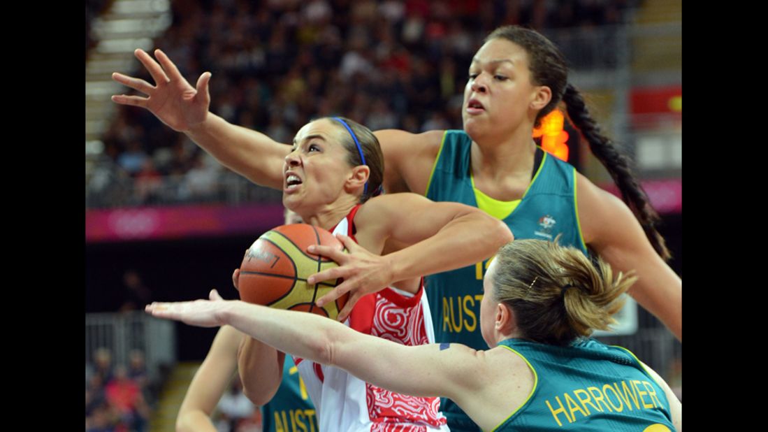 Russian guard Becky Hammon, left, vies with Australian center Elizabeth Cambage during a women's preliminary round basketball match.