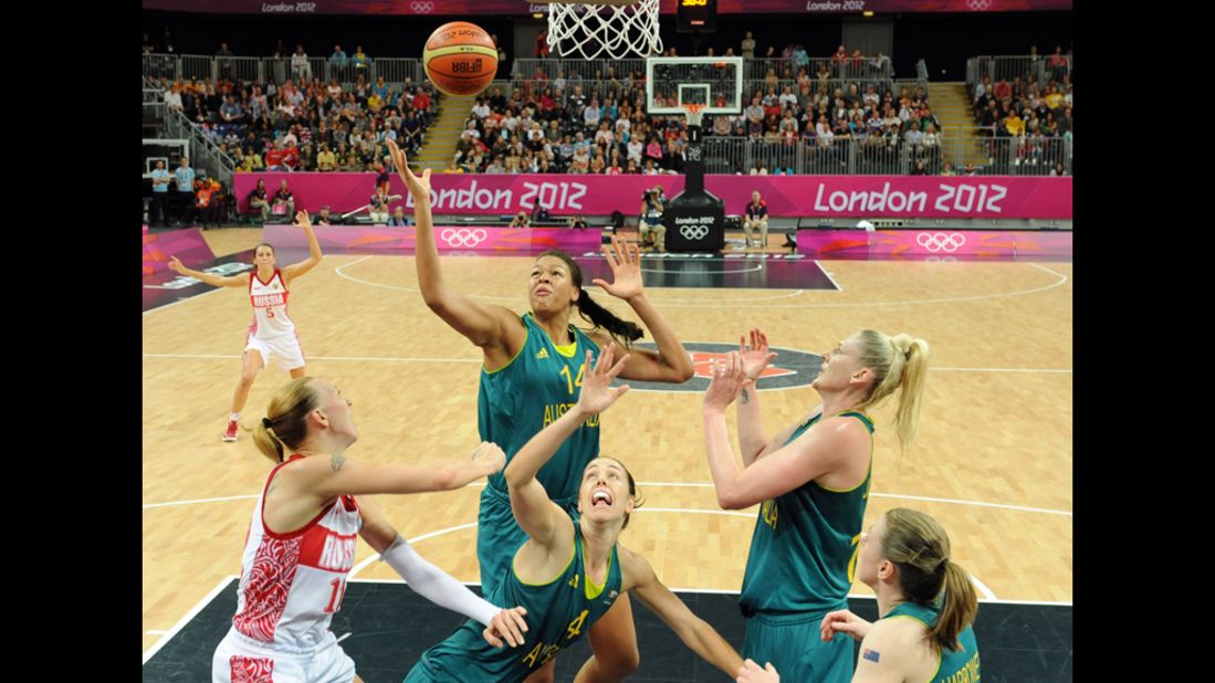 Russian center Irina Osipova, left, faces off with Australian center Elizabeth Cambage, center, during a women's preliminary round basketball match.