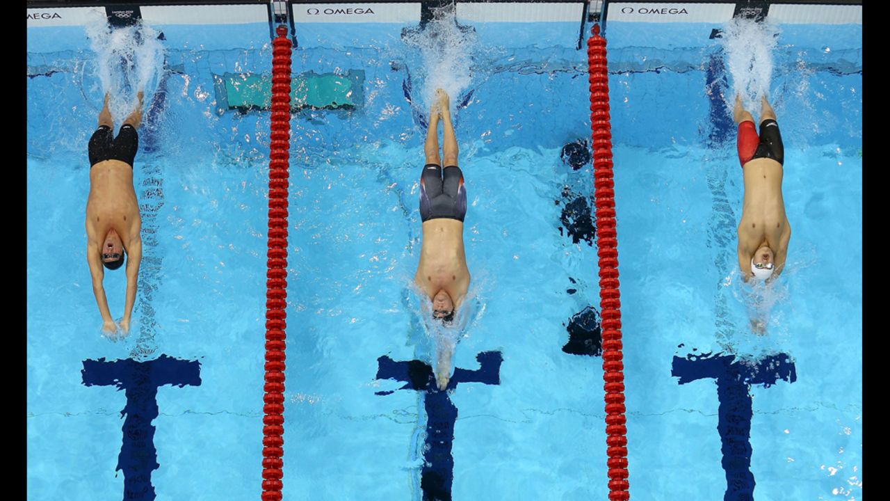 Left to right: Ryan Lochte, Tyler Clary and China's Fenglin Zhang compete in the men's 200-meter backstroke final.
