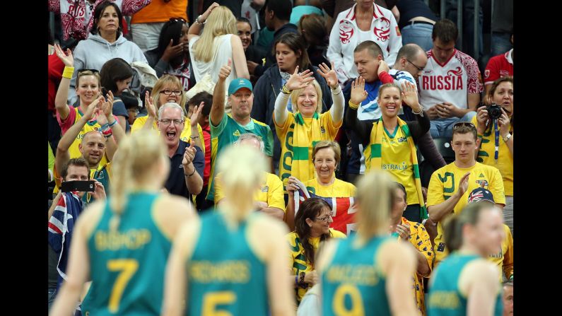 Fans cheers Australia's players as they leave the court after defeating Russia in a women's basketball preliminary round.