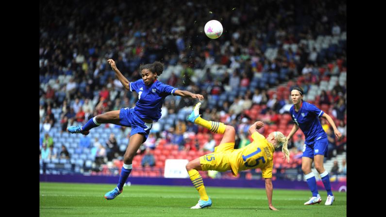 France's Laura Georges, left, battles for the ball with Caroline Seger of Sweden during the women's football quarterfinal match.