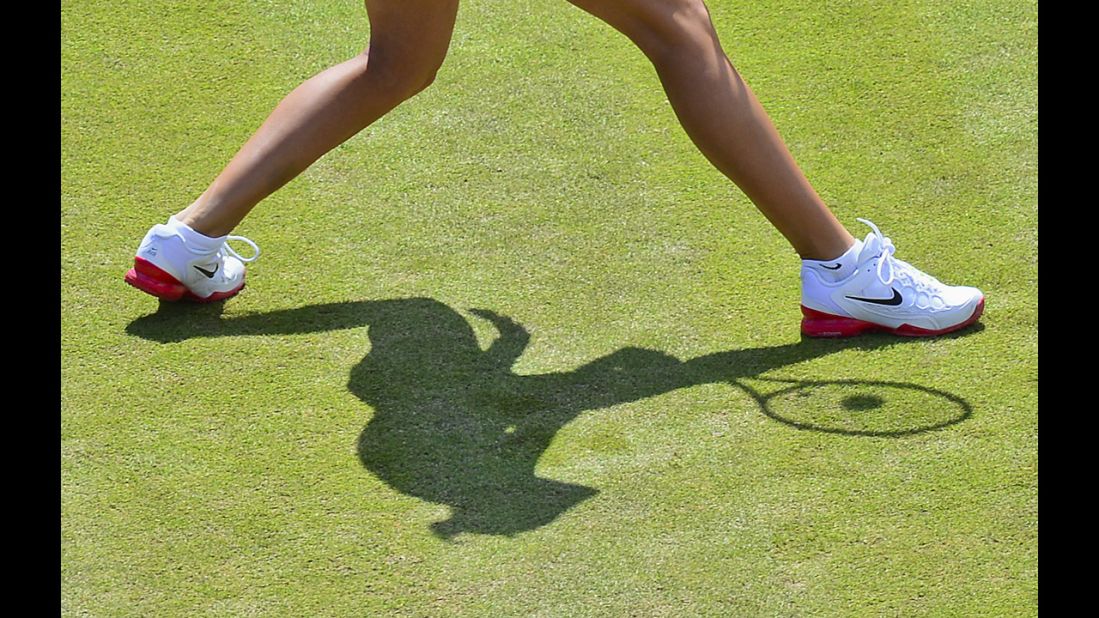 The Czech Republic's Andrea Hlavackova casts a shadow on the court as she warms up before a women's double tennis semifinal against Americans Liezel Huber and Lisa Raymond.