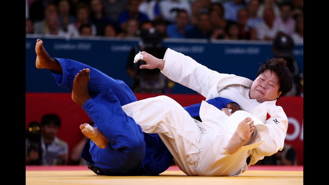 China's Wen Tong, in white, and Idalys Ortiz of Cuba compete in the women's over 78-kilogram judo event.