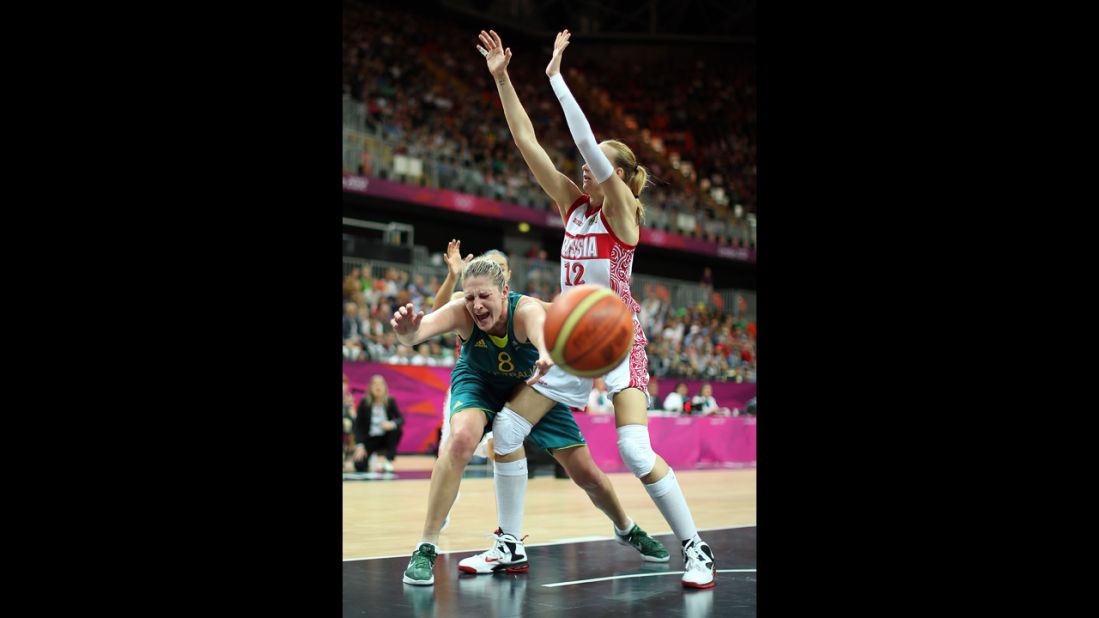 Australia's Suzy Batkovic, center, reacts after losing the ball under pressure from Russia's Irina Osipova during a women's basketball preliminary round.