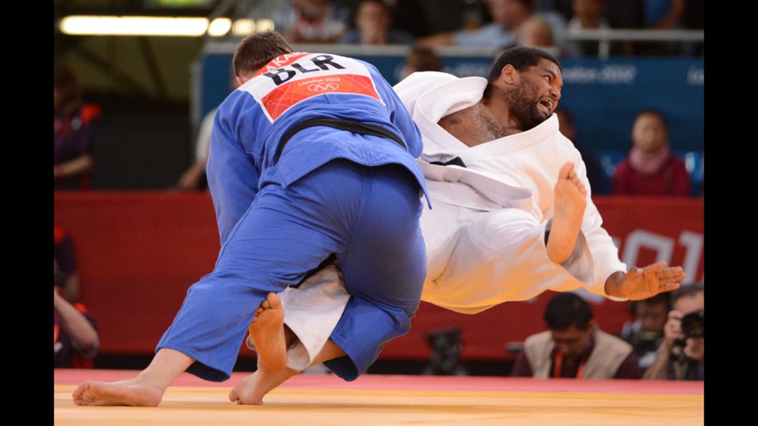 Ihar Makarau, left, of Belarus competes with Cuba's Oscar Brayson during the men's over 100-kilogram judo repechage match.