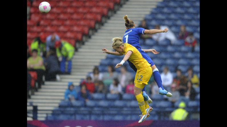 Corine Franco of France and Marie Hammarstrom of Sweden battle for the ball during a women's football quarterfinal match.