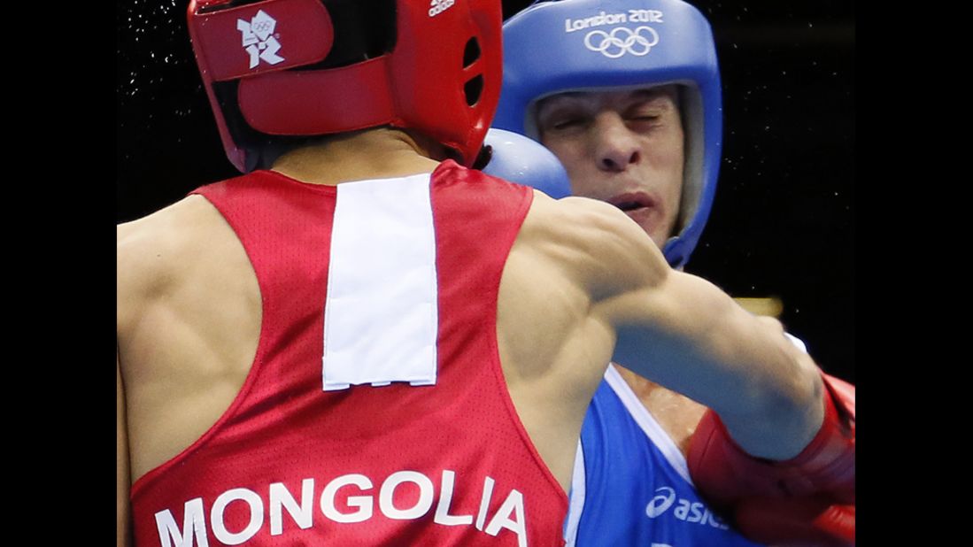 Italy's Vincenzo Picardi, right, is on the receiving end against Tugstsogt Nyambayar of Mongolia during a flyweight match.