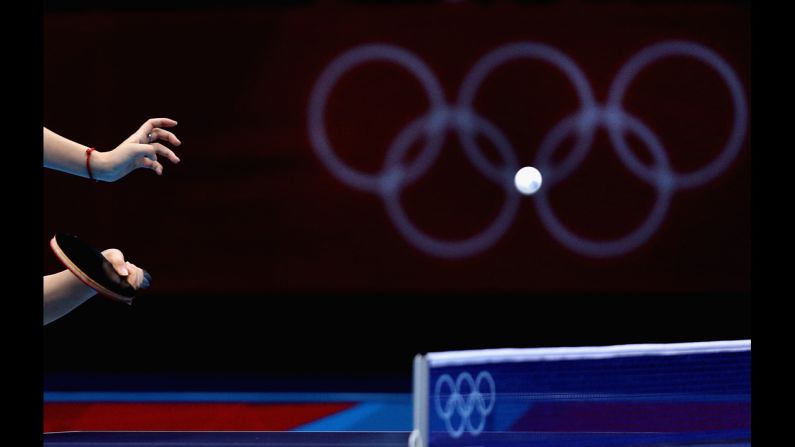 Tianwei Feng of Singapore competes during the women's team table-tennis match against Poland.