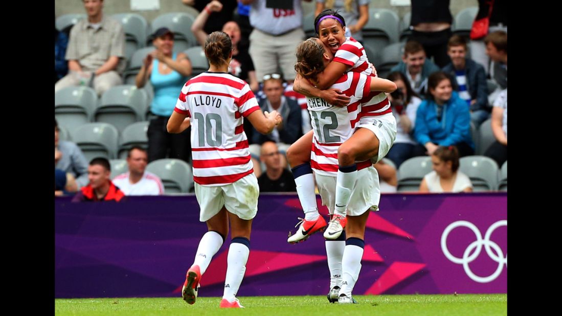 American Sydney Leroux, right, celebrates with teammates Lauren Cheney, center, and Carli Lloyd after scoring against New Zealand during the women's football quarterfinal match.