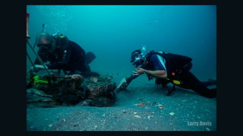 TISIRI divers, including Joe Kistel, inspect the wreckage of a plane on the ocean floor. 